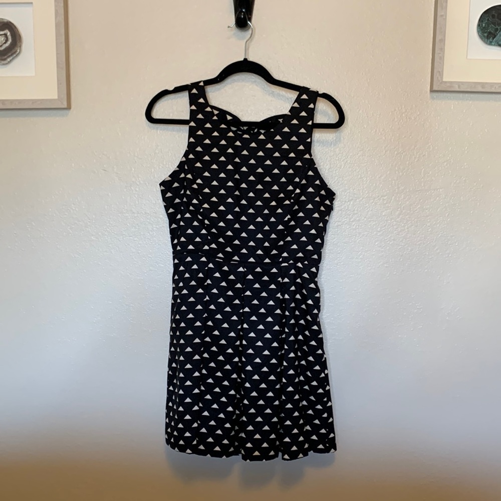 Black geometric mini dress with back bow detail and side zip closure